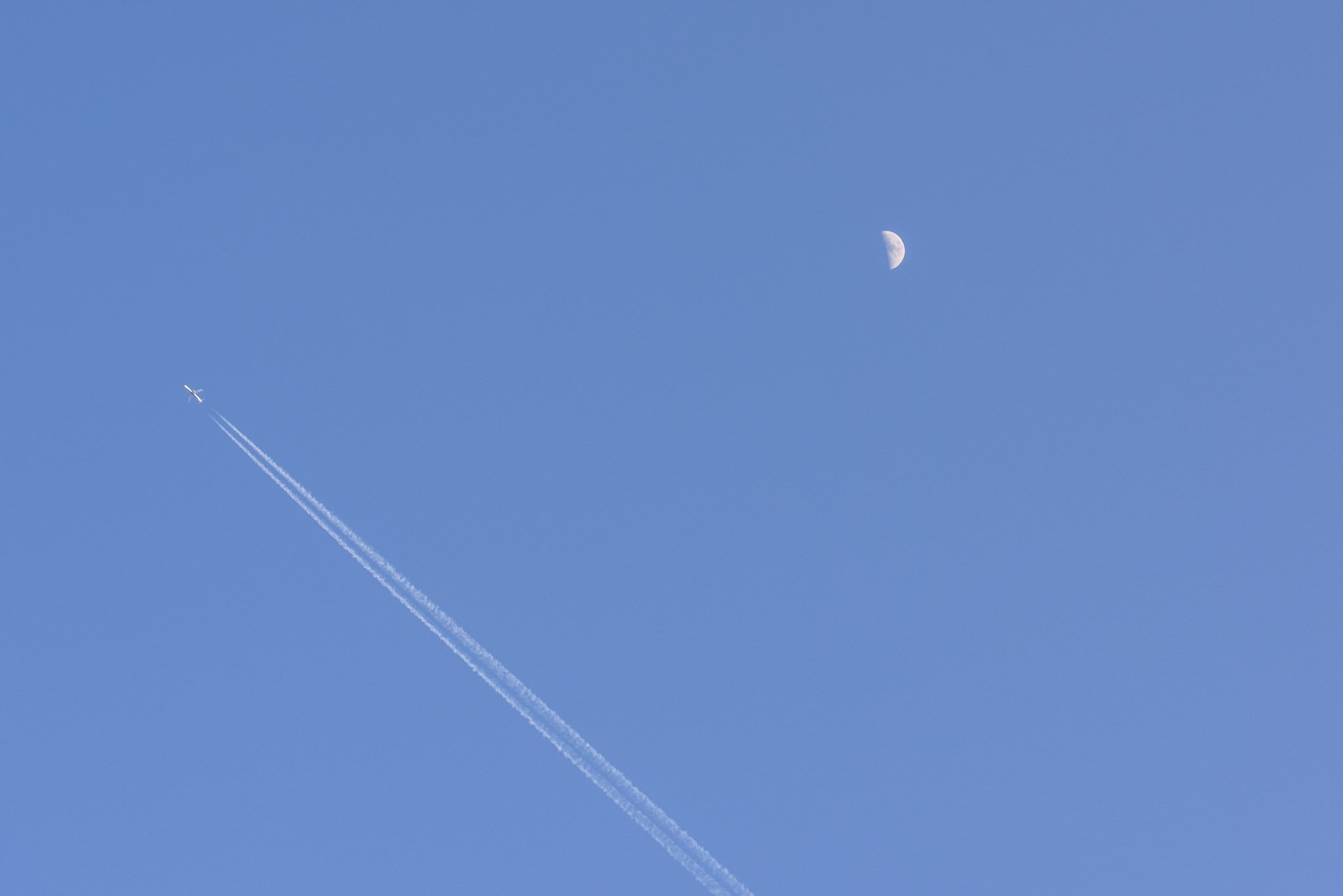 Plane moon and vapor trails